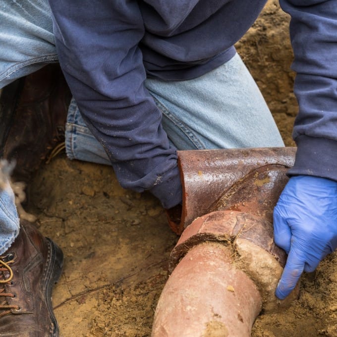 Man Repairing Sewer Line
